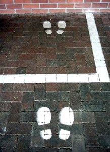 Footprints painted in front of a cash till to guide users