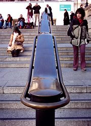 One of the handrails in Trafalgar Square: tourists at the top take photos