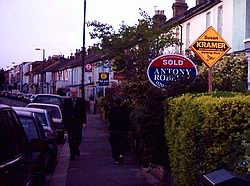 Orange Susan Kramer diamonds compete for space with estate agent signage