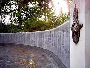 The sun sets behind the memorial wall