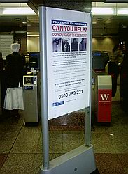 'Can You Help' sign on Tube with bombers' photos