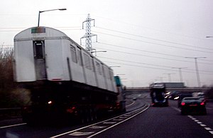 Tube train on the back of a lorry on the motorway: 2