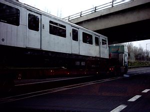 Tube train on the back of a lorry on the motorway: 3