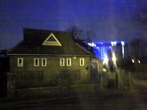 Bright, blurred lights from a hotel in the distance at night