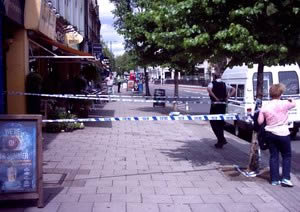 Police and a taped-off pavement