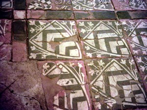 Heraldic tiles form a historic floor