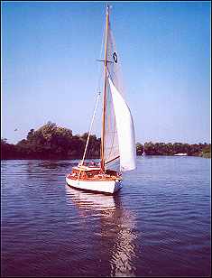 This lovely picture shows all the best characteristics of a Broads sailing yacht - forget about hiring any more motor cruisers!